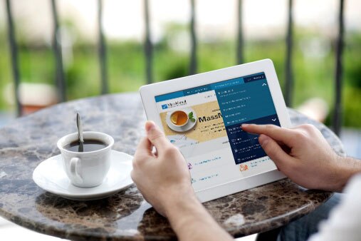 Person sitting at a table with coffee looking at a table